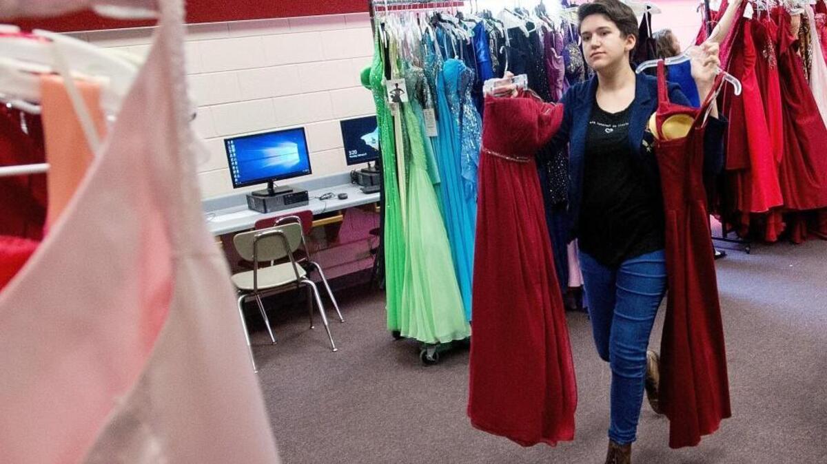 Warner Robins High School freshman Bela Venditti sorts through dresses while helping prepare for last year’s Dress Drive.