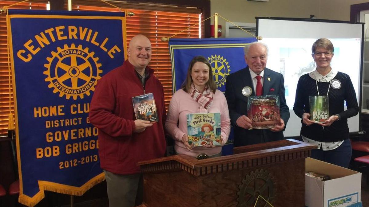 Mike Jackson, from Thomson Middle School, and Amy Hayes, from Centerville Elementary School, are pictured with Jack Steed and Erin Kitchens from the Rotary Club of Centerville and some of the dozens of books the club recently donated to three schools.