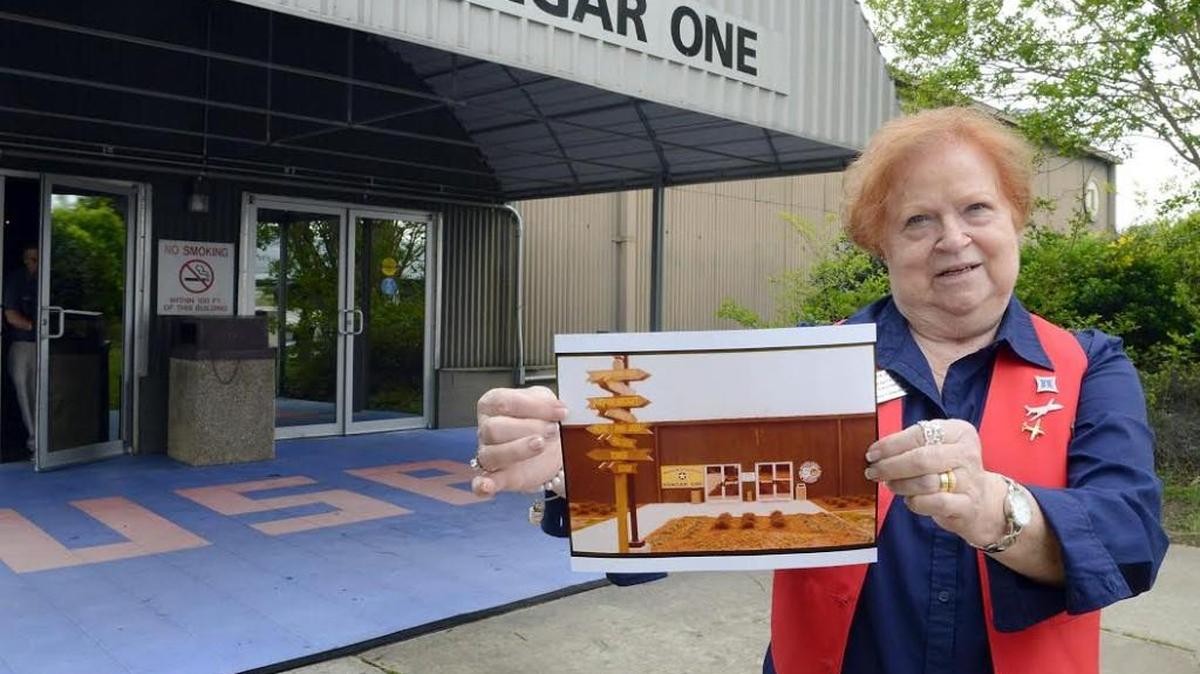 Linda Doyle, Museum of Aviation volunteer, shows an old photo of Hangar One.