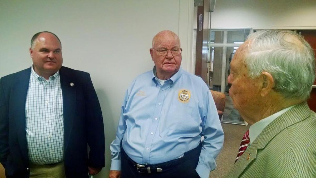 Houston County Sheriff Cullen Talton, center, speaks with Commissioner Tom McMichael, right, and Personnel Director Ken Carter following the commission meeting Tuesday in which funding was approved to start building a gun range for deputies.