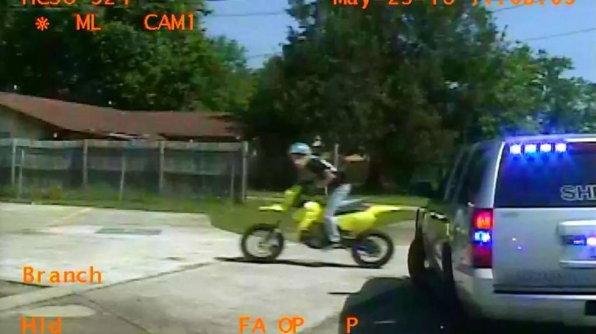 A suspect flees on a dirt bike.