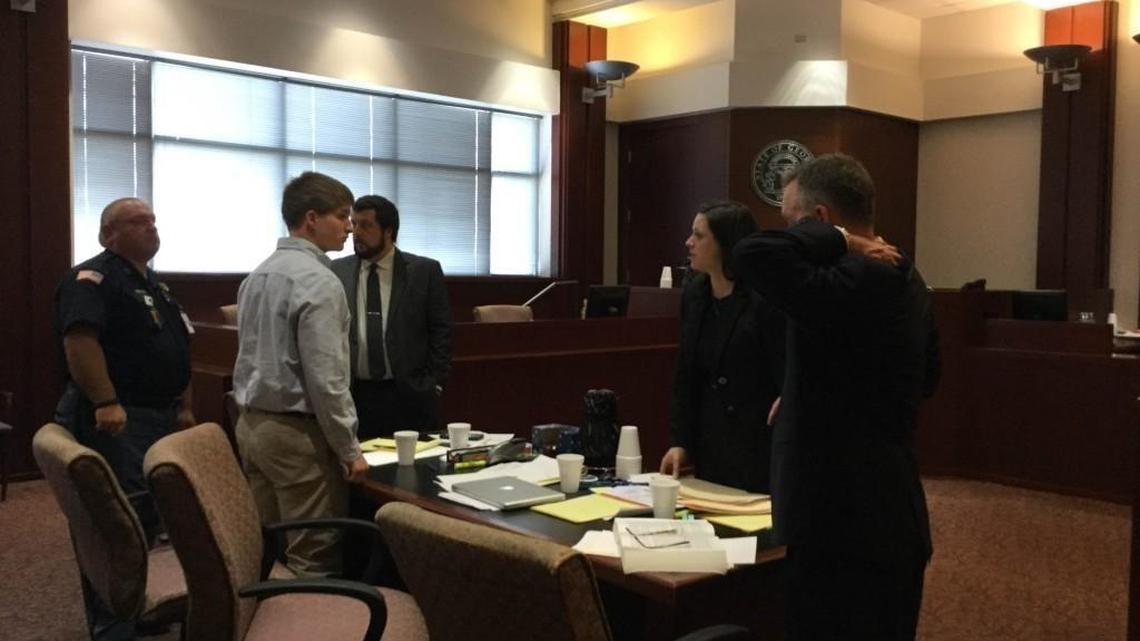 Kaden Chase Barefoot, 14, stands at the defense table last month after his trial was postponed due to a jury selection issue.