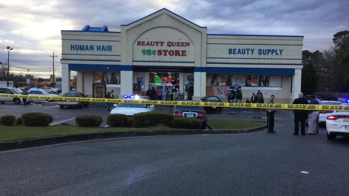 Investigators gather evidence at the Beauty Queen 98¢ Store in Macon, Ga, where a man drove himself after being shot Tuesday evening.