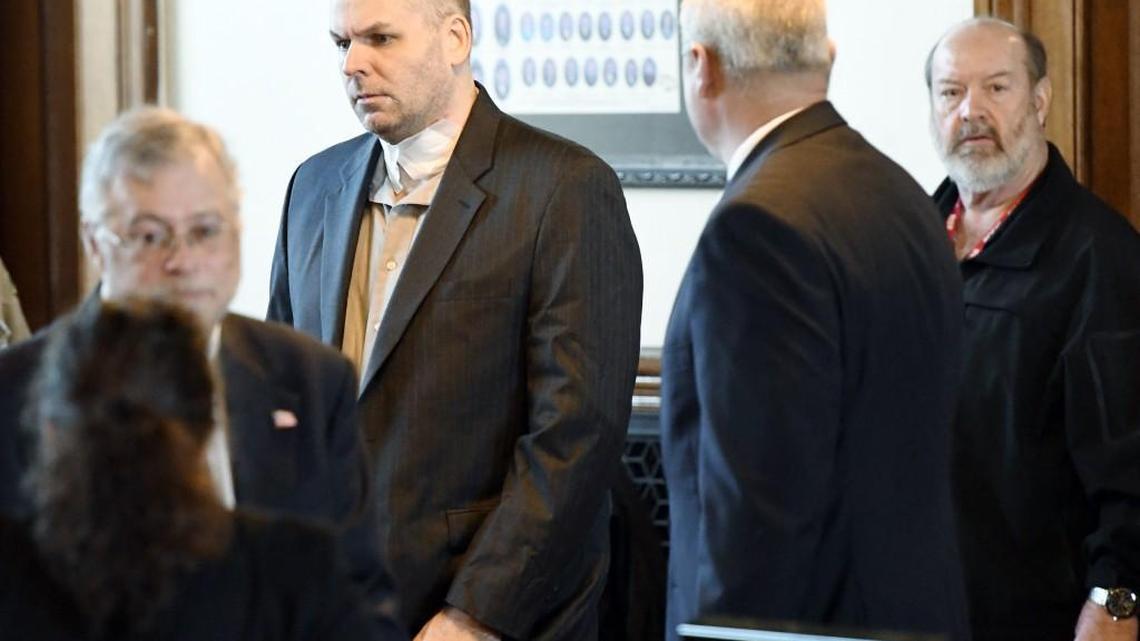 Christopher Calmer walks into Monroe County Superior courtroom with a large bandage on his neck Friday morning. Calmer who is charged in the shooting death of a Monroe County deputy, tried to kill himself on Thursday, his attorney said in court Friday.