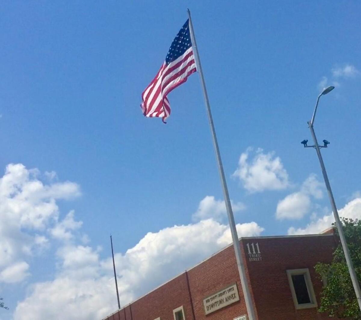 The flag outside the Bibb County sheriff’s annex at the corner of Third Street and Riverside Drive in downtown Macon.