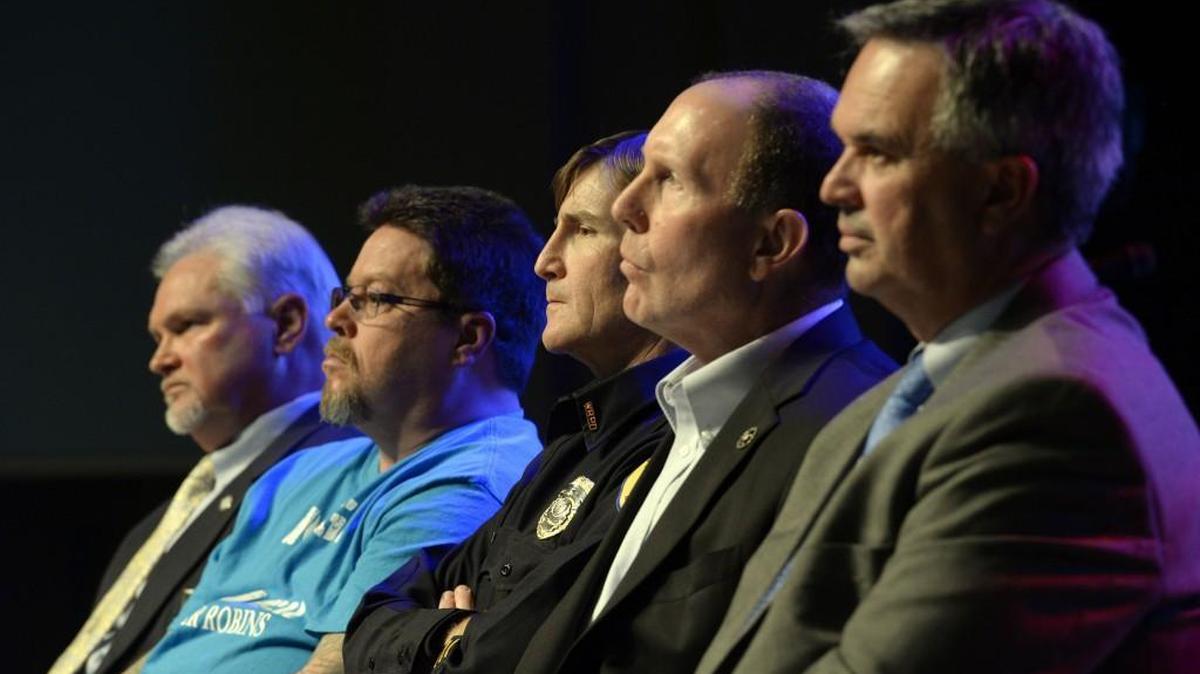 Houston County District Attorney George Hartwig, left, “Enough is Enough Warner Robins” member David Reid, Warner Robins Police Chief Brett Evans, area Crimestoppers Chairman Warren Selby and Warner Robins Mayor Randy Toms listen to an introduction by Cody Smith at a town hall meeting at Southside Baptist Church in Warner Robins on Tuesday.