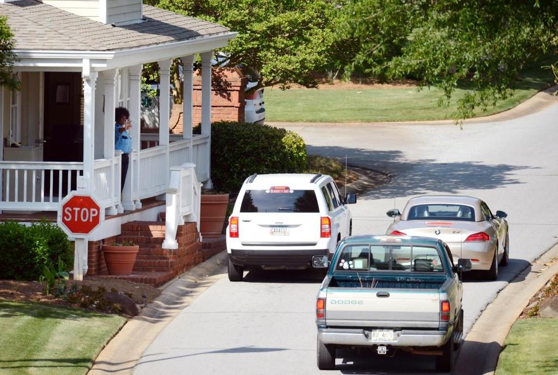 A guard waves at residents as they enter the Reynolds Plantation Great Waters community on Lake Oconee soon after the Dermonds were killed in 2014.