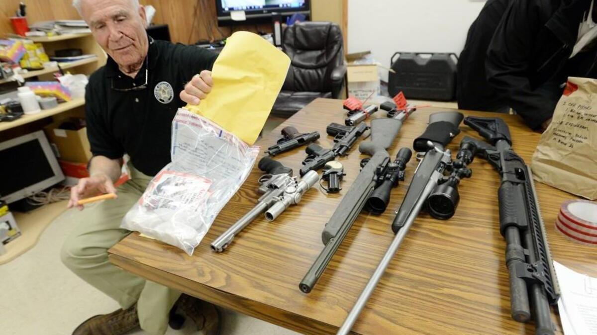 Baldwin County Sheriff Bill Massee, left, holds 9 ounces of heroin deputies confiscated along with stolen guns that will be tested to determine if they were used in any of the county's unsolved drive-by shootings.