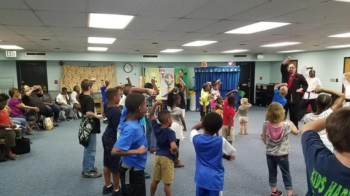 A Georgia Martial Arts instructor gives a demonstration on techniques at Shurling Library during a summer reading event.