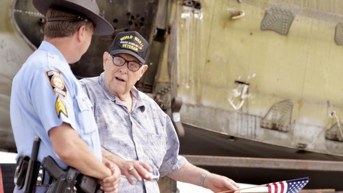 World War II veteran Crawford Hicks talks to Georgia State Patrol Sgt. David Holland next to a B-17 being moved to the Museum of Aviaion in 2015. Hicks, who was held prisoner by Germans, is recovering in a Dublin VA hospital after a recent fall in his driveway.