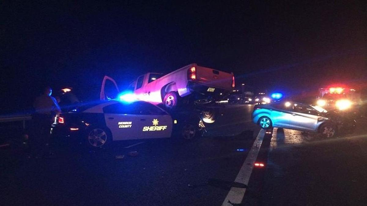 A Monroe County sheriff's deputy escaped serious injury when he was struck while assisting a motorist early Sunday.