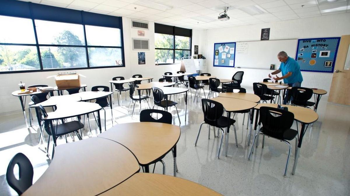 Cirrus Academy 8th grade Georgia Studies teacher decorates his room one Friday morning in July 2016. The new charter school opened its doors to students on Aug. 1.