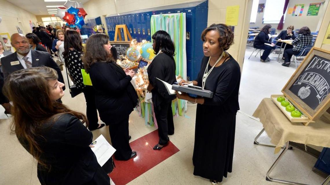 Jajuandraula Taylor, right, welcomes Taylor Wilburn, left, to Springdale Elementary School’s room during the Bibb County teacher fair in March 2016 at Howard High School. The district’s 2017 fair is Saturday.