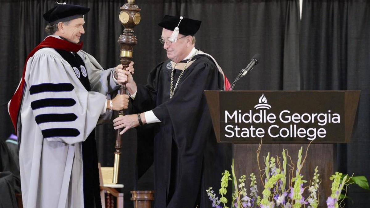 Middle Georgia State College president Christopher Blake, left, accepts a scepter from Hank M. Huckaby, Chancellor of the University System of Georgia during Blake's inauguration ceremony in October 2014.
