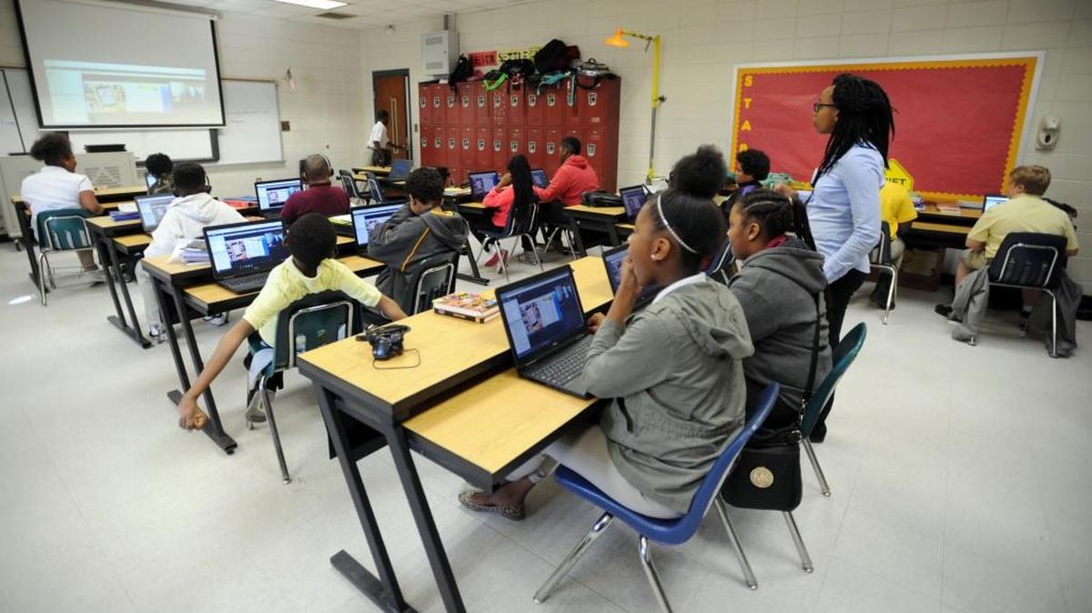 In this 2016 file photo, students use their laptops in a Weaver Middle School classroom to take an English class from a teacher in Texas via the internet. School districts, including Bibb, use E-rate federal funding to enhance their technology infrastructure and ensure uninterrupted connectivity.