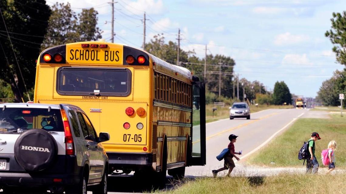 Houston County students walk off a school bus along Highway 41. A centralized transportation facility is one of the final projects that will be completed using 2012-17 education special purpose local option sales tax dollars.
