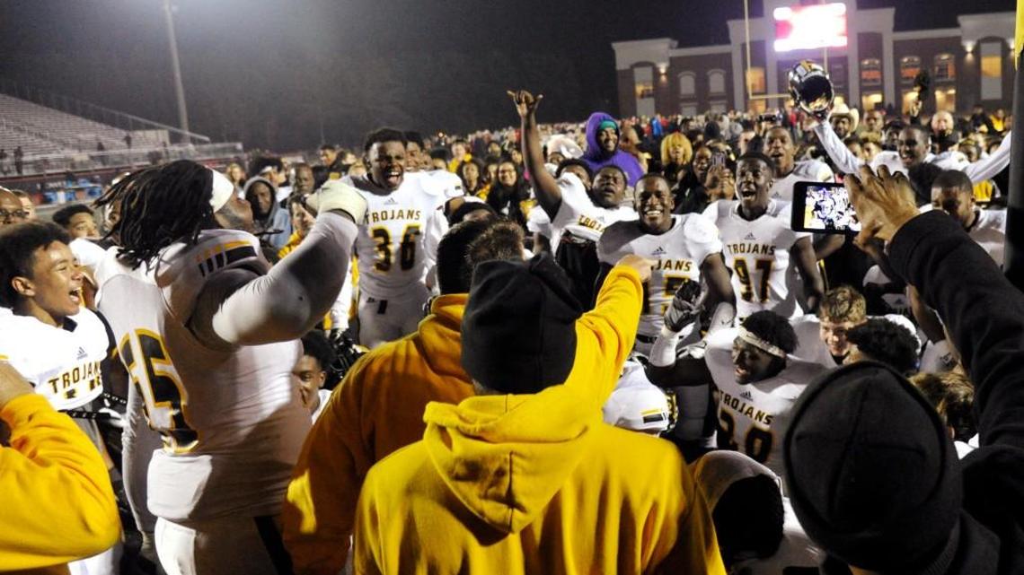 Peach County players celebrate while listening to head coach Chad Campbell after their 28-23 semifinal win over Greater Atlanta Christian School on Friday night.
