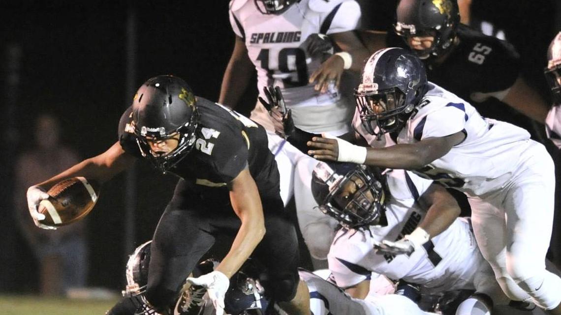 Mary Persons High School running back Zach Harvey powers his way through the defensive line during the Sept. 30, 2016, game against Spalding High School. Mary Persons is playing Cartersville High School in the state semi-finals Dec. 2, prompting Monroe school officials to dismiss all schools early that day.