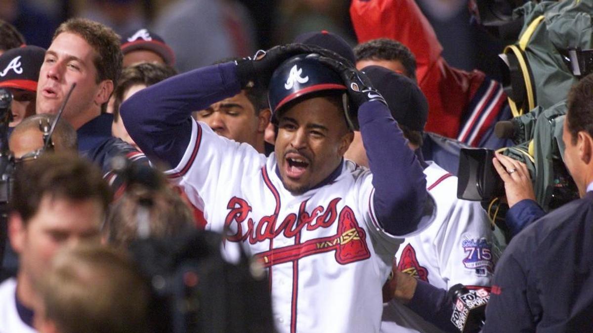 Braves Brian Jordan can hardly hold onto his hat after the Braves won the National League pennant after New York walked in the winning run. The Braves won, 10-9. Today, the professional baseball and football player writes children’s books distributed by a foundation he created to inspire children to seek educational opportunities.