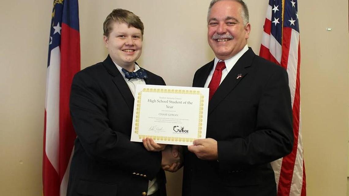 State Superintendent Richard Woods, right, presents the High School Student of the Year award to Chase Gowan of Veterans High School.
