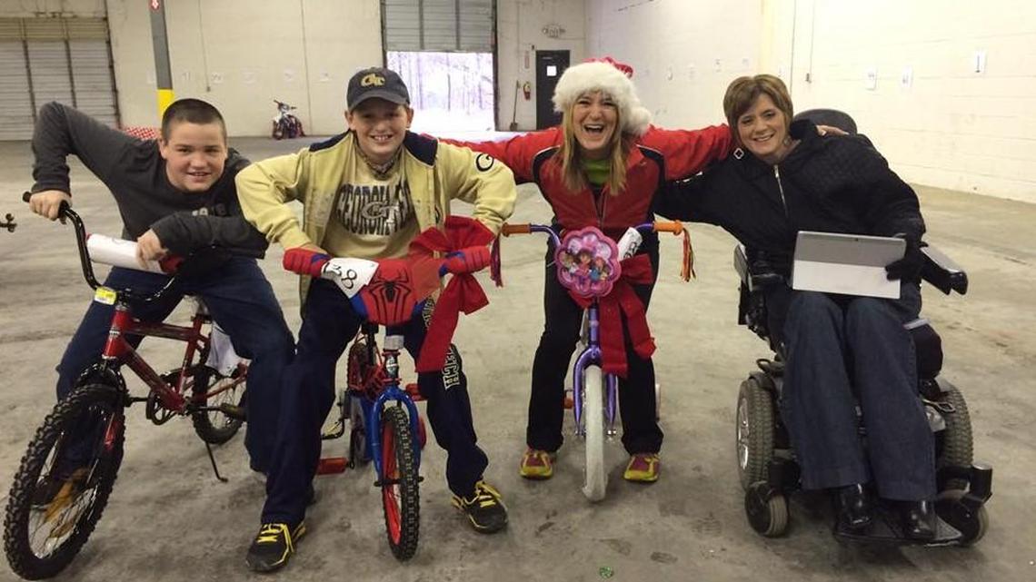 Project Giving volunteers, from left, Reece Woodward, Spencer Slade, Toni Slade and Natalie Woodward are pictured with bikes donated for the Family Christmas Adoption Project.