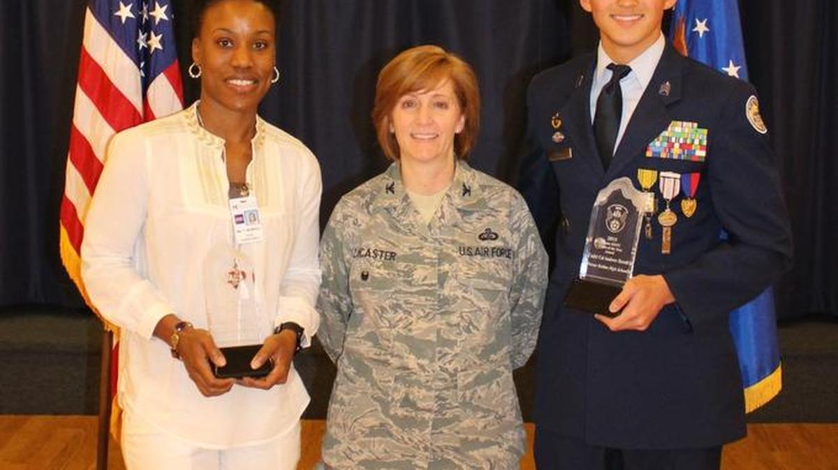 Terra McMillian, left, and Andrew Revolt, right, are pictured with Robins Air Force Base 78 th Air Base Wing Vice Commander Col. Dawn Lancaster
