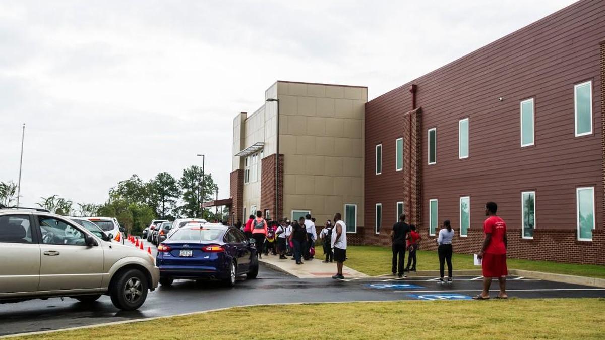 Parents wait outside Macon Charter Academy for school to be dismissed.