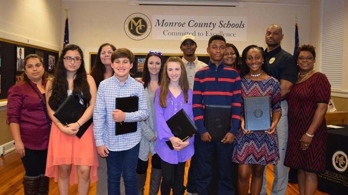 Students in Monroe County's first class of REACH Scholars are pictured with their families.