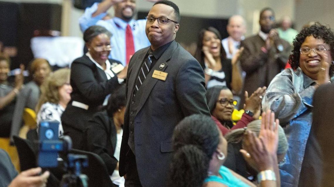 Westside High School teacher Dominique Nichols walks to the stage Monday night to greet Superintendent Curtis Jones after being named 2017 Bibb County Teacher of the Year.