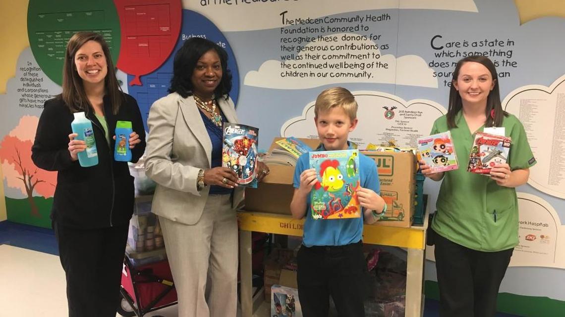 Kay Ray Elementary Teacher of the Year Pamela Johnson, second from left, and student Rowan Woodrich, third from left, who is Mr. Kay Road 2016-17, delivered more than 1,000 items collected by the school to child life specialists at the Children’s Hospital, Navicent Health.