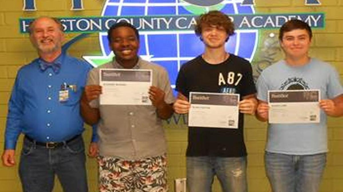 Houston County Career Academy instructor Eli Walker is pictured with students Alundre’ McGhee, Blake Fortier and David Cline, who were among six students to earn their PC Professional Certification in May.