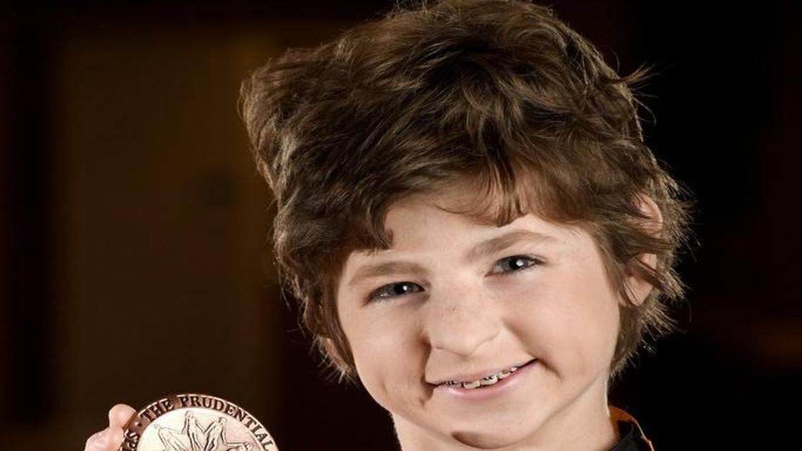 Kelsey Norris, a sixth-grader at Bonaire Middle School, has been named one of the nation’s top 10 youth volunteers. Here, she holds the medal she received after winning the state award in March.