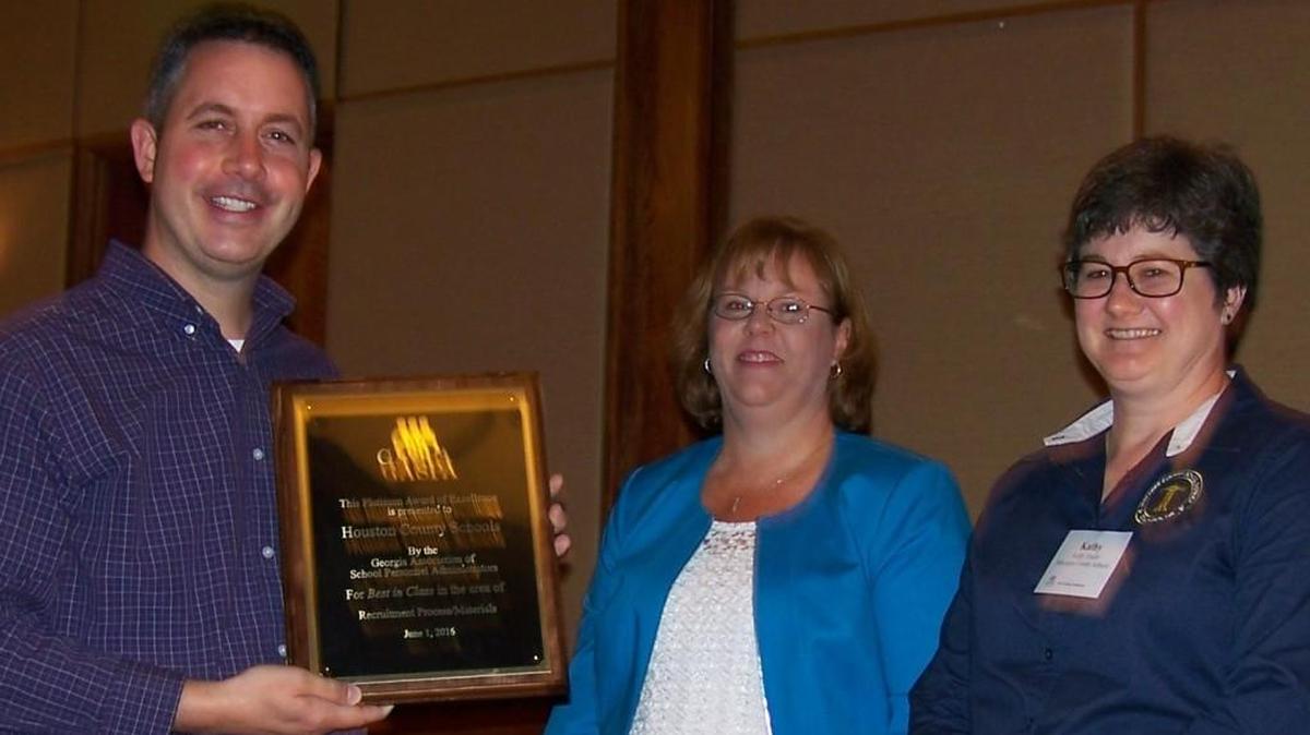 Houston County personnel director Richard Rogers accepts an award on behalf of his department.