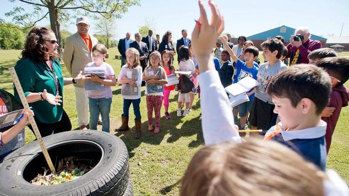 Eagle Springs Elementary 3rd grade teacher Jennifer Nash, left, asks a question to her students while creating a compost at school. Houston County schools received a CCRPI score of 78 on Tuesday.