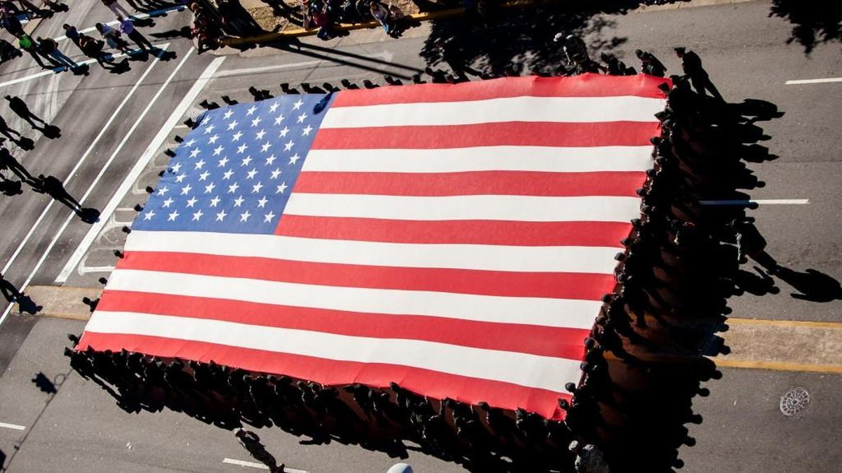 A huge American flag is carried down Sumter Street during a Veterans Day Parade in Columbia, South Carolina.