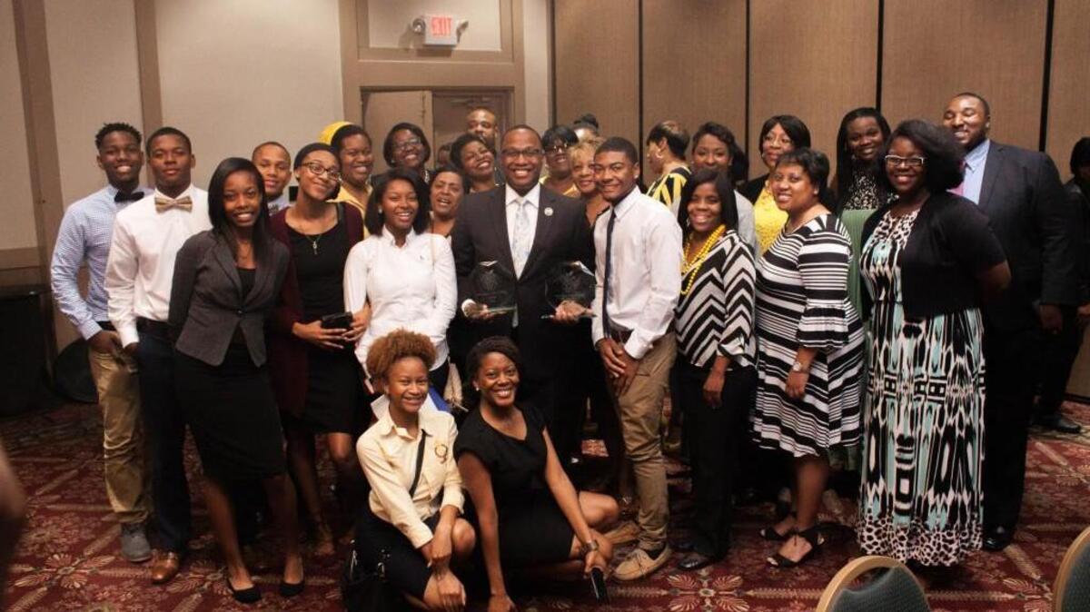 Westside High School teacher Dominique Nichols, center, is surrounded by friends, family and co-workers after being named runner-up for the 2018 Georgia Teacher of the Year on Monday.