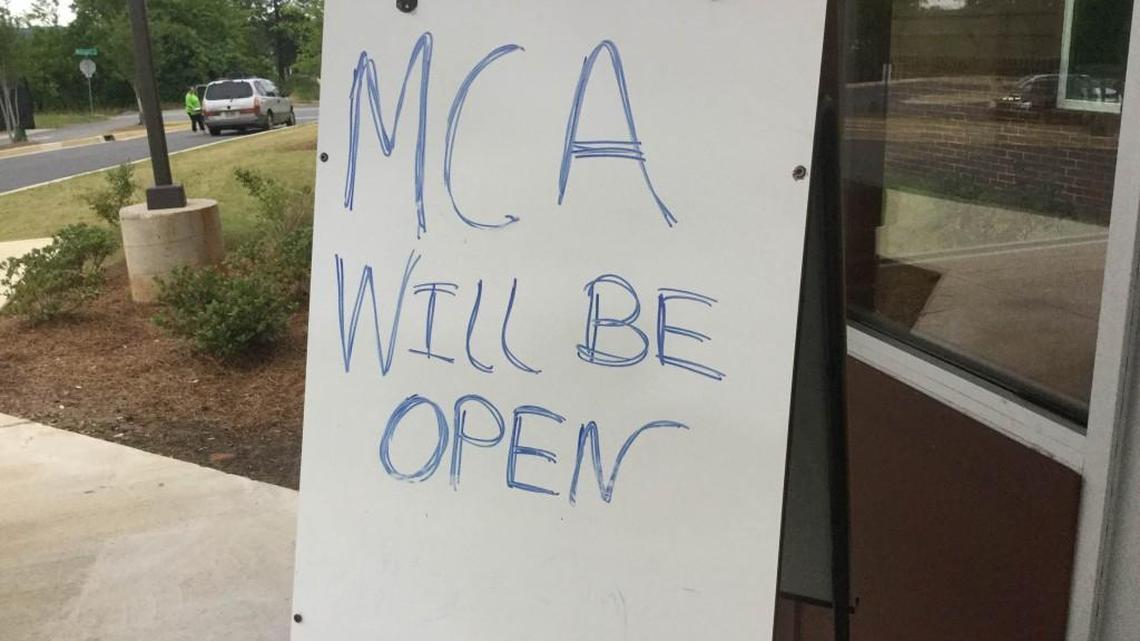 A sign outside Macon Charter Academy during a recent meeting of the school’s governing board expresses parents’ intent to keep MCA open.