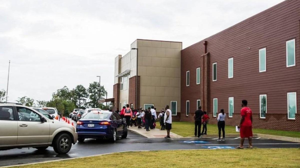 Parents wait outside Macon Charter Academy for school to be dismissed.