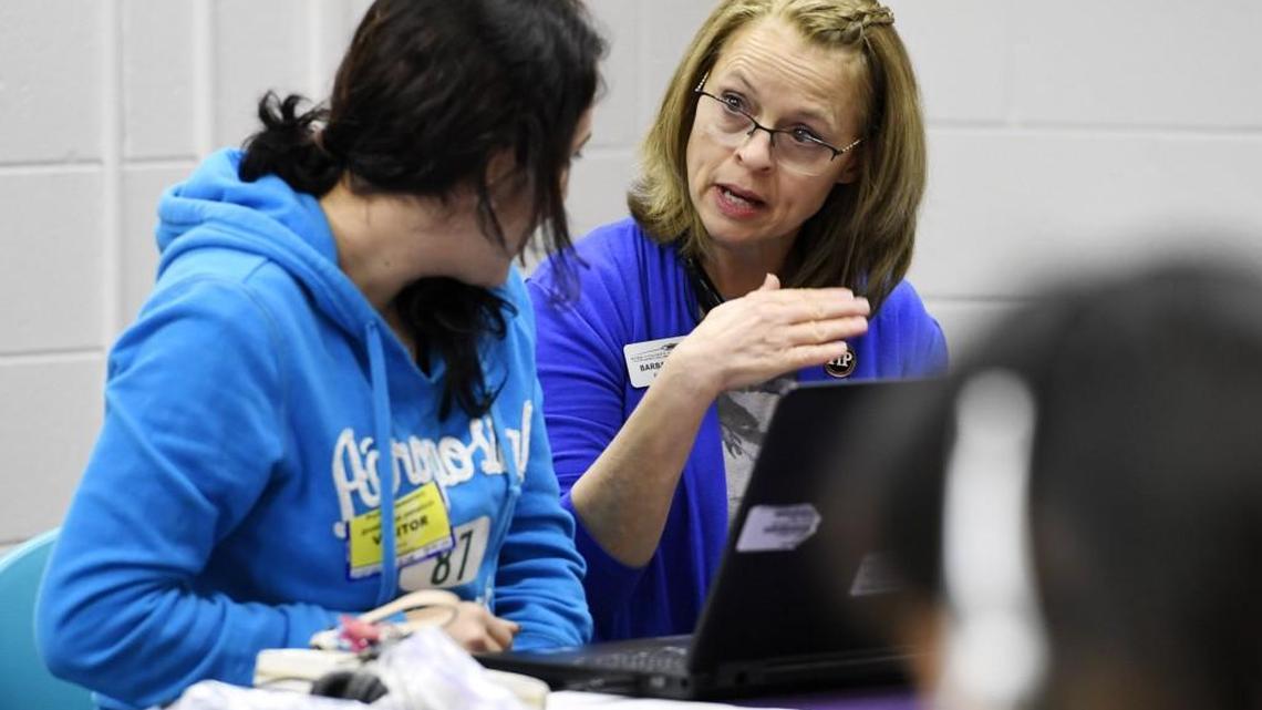 Guadalupe Penaloza, left, is assisted in setting up her account by Bibb school system ESOL lead teacher Barbara Leggett on her first day of English class at Porter Elementary on Jan. 27. Porter is one of two Bibb County schools that offer English classes for parents who speak other languages.