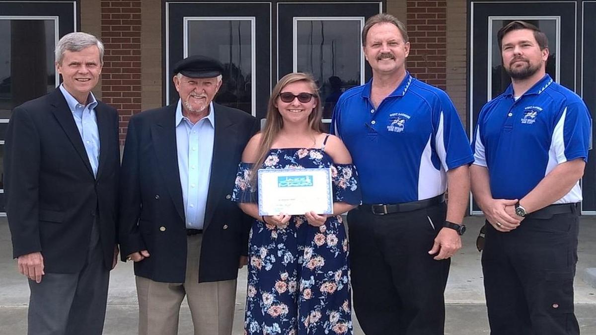 Harleyh Merritt, center, received the $1,000 Macon Youth Scholarship from the Jazz Association of Macon. Here, she is pictured with Tom Woodbery, left, Jazz Association president; Chet Burchfield, of the Jazz Association; West Laurens High School Director of Bands Michael Dukes; and West Laurens Assistant Band Director Richard Horne.
