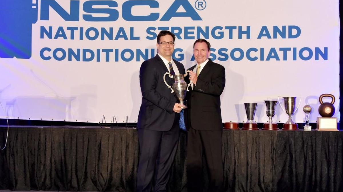 Mercer University professor Bill Holcomb, right, receives the Sports Medicine/Rehabilitation Specialist of the Year Award at the 40th Annual National Strength and Conditioning Association Conference in Las Vegas.