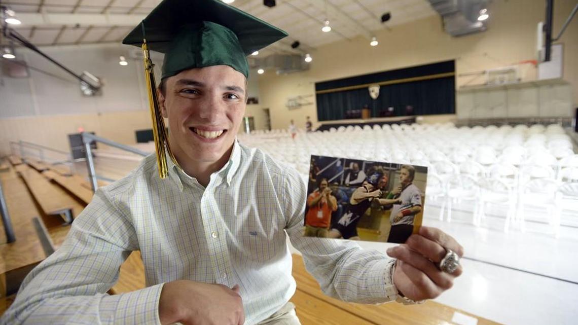 Westfield School senior Chandler Dean holds a photograph of one of his most exciting moments — wrestling for a state championship. He lost two of his fingertips in a car wreck, but that didn’t keep him away from wrestling.