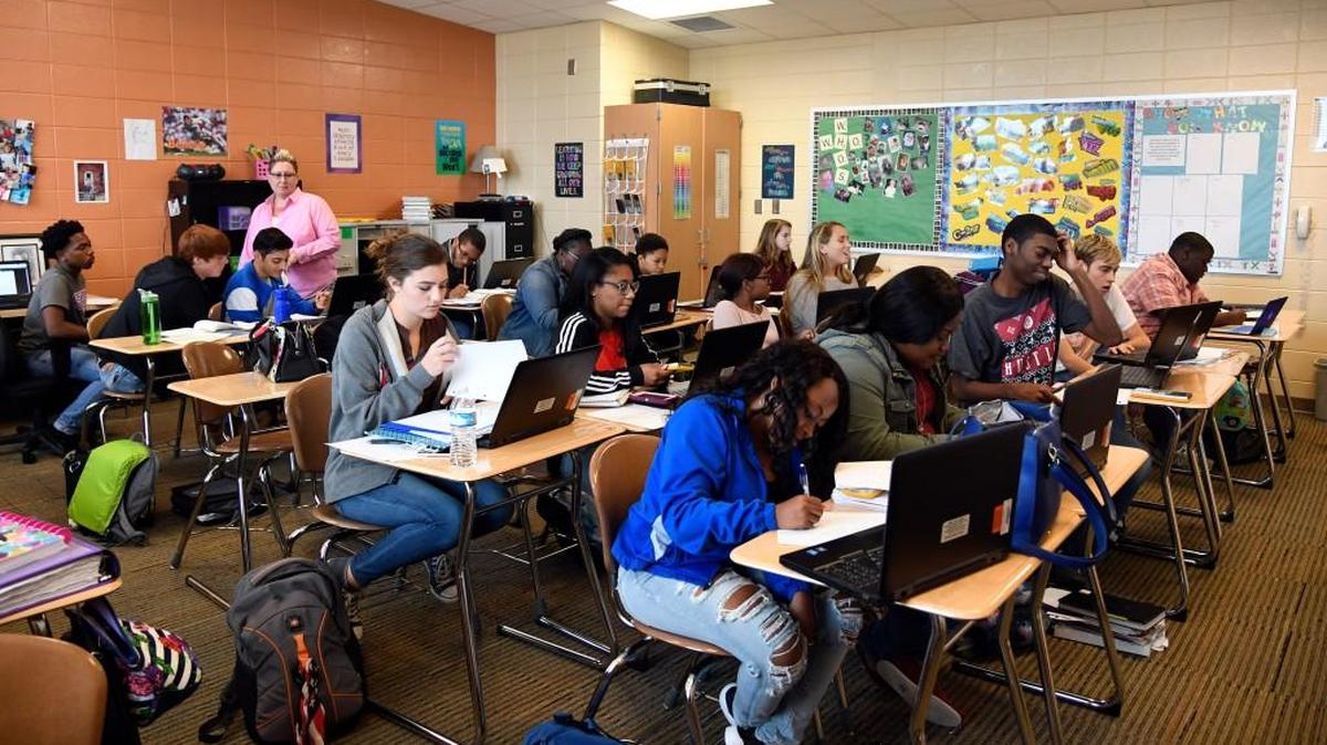 Central teacher Shannon McBrair, standing, helps her students prepare for upcoming International Baccalaureate and Advanced Placement tests in her math class.