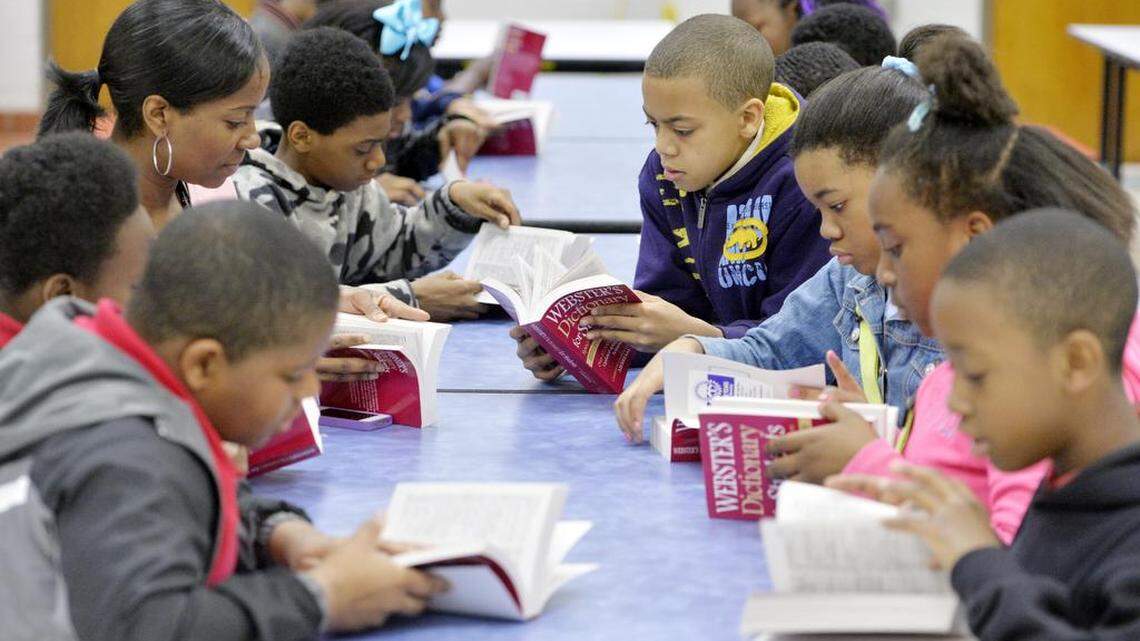 L.H. Williams fifth-grade students look over the new dictionaries they received from the Rotary Club of Macon on March 4, 2014.
