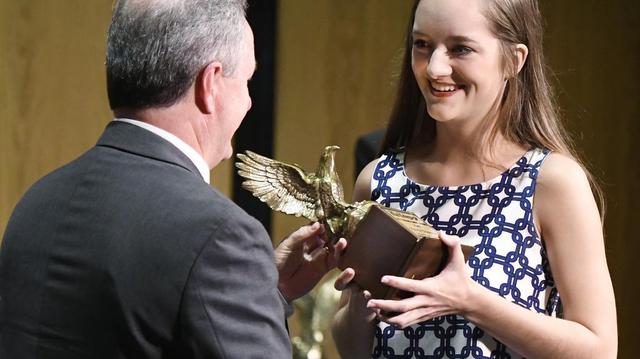 Tattnall Square Academy senior Kenzie Dingmore accepts the 2017 Golden Eagle Award for math from Telegraph Publisher Don Bailey Tuesday night.