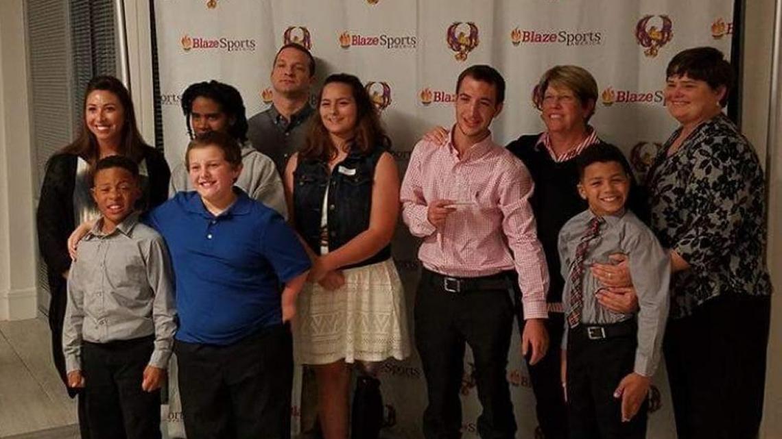 Houston County Sharks members accept a Triumph of the Human Spirit Award in Duluth on Nov.13, 2016. Pictured, front row from left, Keyon Williams, Gavin Sien and Jaden Screen; back row, Coach Laura Tinsley, Kierra Miles, Coach Stephen Roberson, Jordan Kozloski, Grady Hilburn, Coach Brenda Arnett and Coach Christy Jones.