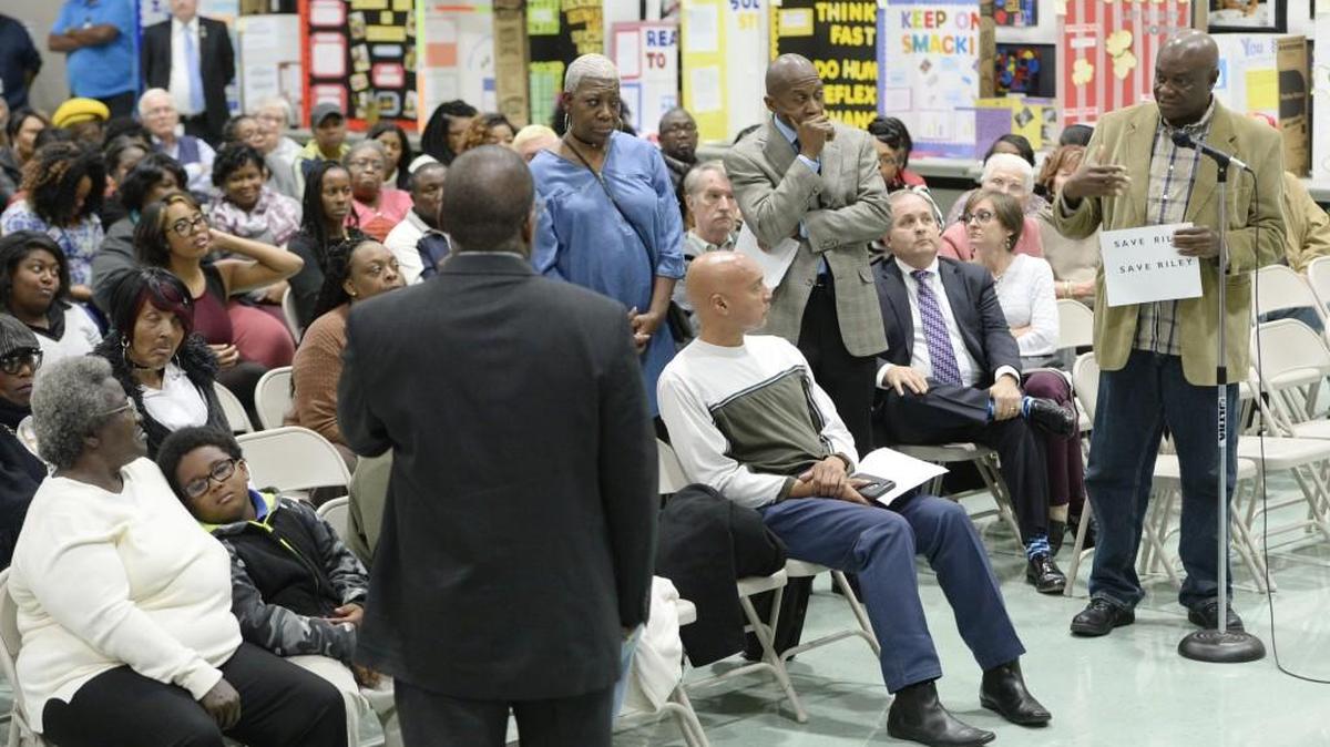 People line up to ask Superintendent Curtis Jones, left, questions about the prospects of closing Macon elementary schools.