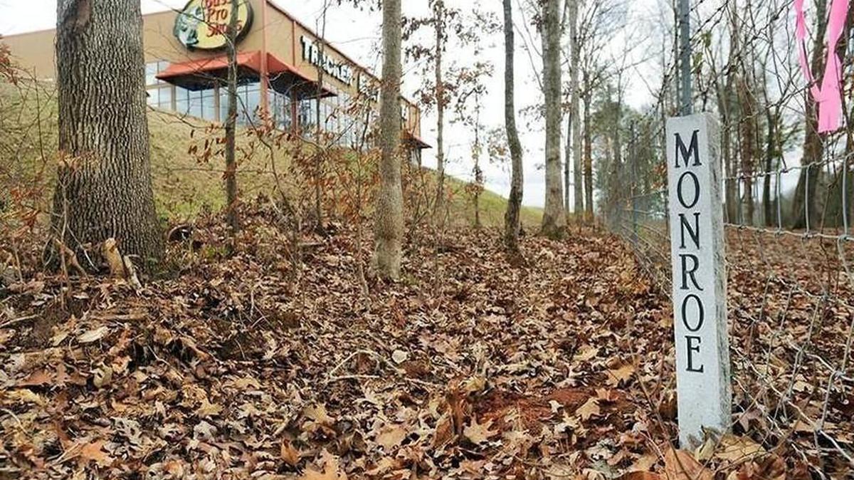 A marker for the Macon-Bibb/Monroe line on the back corner of the Bass Pro Shops property near Interstate 75 in Macon is pictured in January 2009.