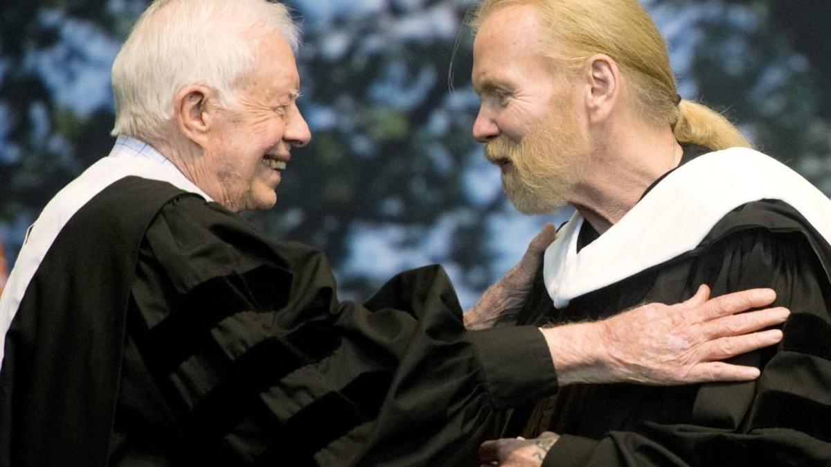 Former President Jimmy Carter and Rock and Roll Hall of Famer Gregg Allman embrace at the 2016 Mercer commencement This year’s has been rescheduled for August due to coronavirus concerns.