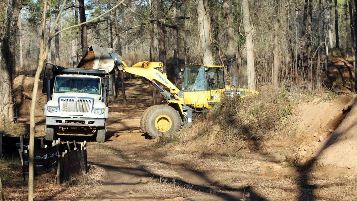 A Houston County work crew Wednesday moves dirt from a site at Wellston Park in Warner Robins that is slated to become a dog park.